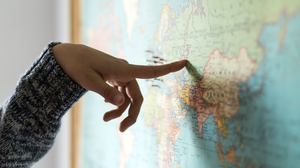 Ein Finger deutet auf eine Weltkarte