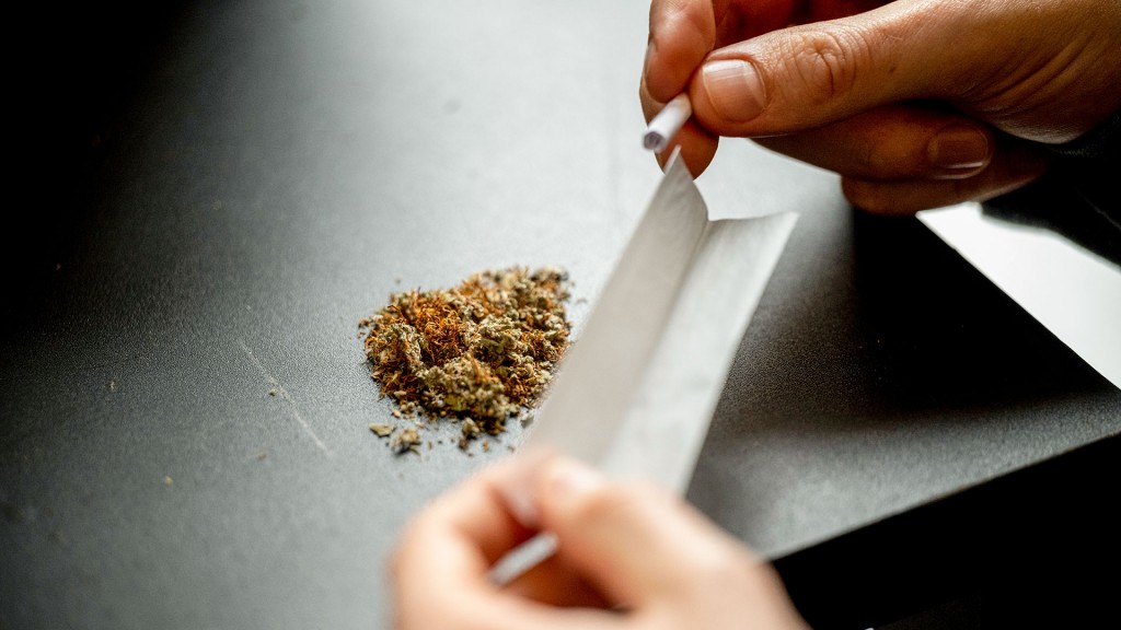 Ein Mann dreht sich einen Joint mit Tabak und Cannabis